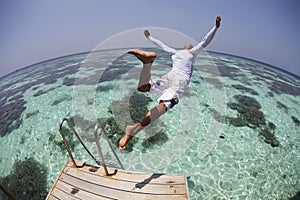 Man dive in blue lagoon photo