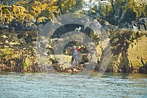 Man diver without a hand set out to dive near island