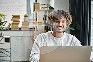 A man of diverse background sits