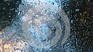 A man dives into a swimming pool with an action camera, a frame in a swimming pool from under the water