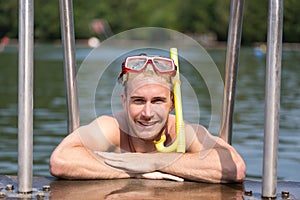 Man with diving goggles at public swimming pool
