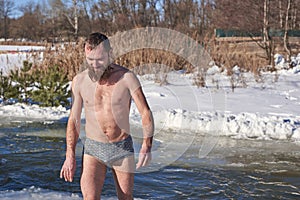 A man after diving into icy water on a Christian holiday