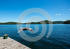 Man diving into a lake in the summer