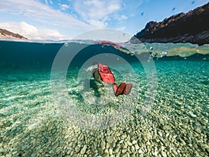 man in diving mask snorkeling in sea water