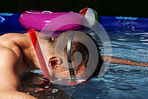 Man diving in a portable swimming pool