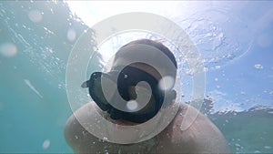 man in diving scuba mask swimming underwater