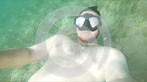 man in diving scuba mask swimming underwater