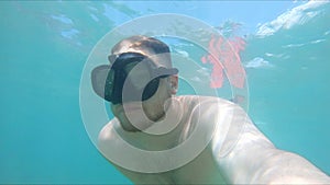 man in diving scuba mask swimming underwater