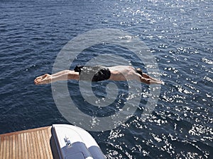 Man Diving Into Sea From Yacht