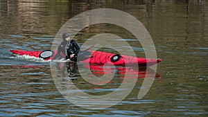 A man in a diving suit makes a coup by kayak