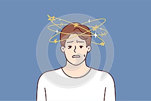 Man with dizziness and stars flying around head looks at camera in confusion after blow or fall