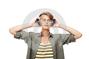 Man, DJ and relax with headphones for audio streaming or listening to music against a studio background. Male person or