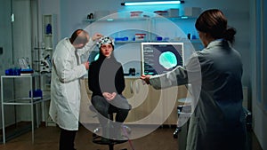 Man doctor examining sensors of eeg headset, monitoring brain function