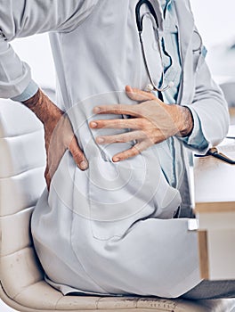 Man, doctor and hands with back pain from injury, accident or posture sitting on chair at the hospital. Closeup of male