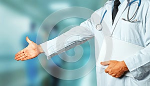 Man Doctor With Medical Card Holds Out His Hand To Say Hello. Greeting Patient. Healthcare Medicine Concept
