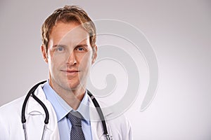 Man, doctor and physician in studio, portrait and medical professional on gray background. Male person, healthcare and