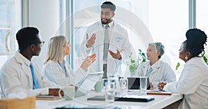 Man, doctor and team in meeting for healthcare, planning or strategy together at hospital or office. Group of medical
