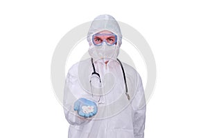 Man in doctor uniform with pills in hands on isolated on a white backgr