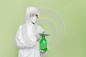 Man doctor wearing full personal protective equipment on green background.