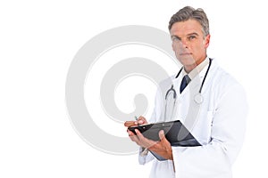 Man doctor writing on clipboard with pen