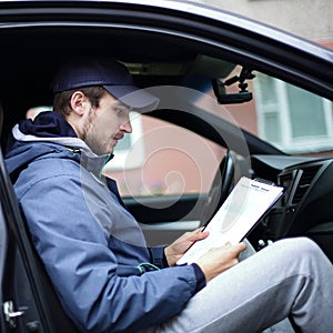 Man with documents sitting in the car