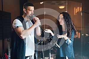 A man does chanting at a vocal lesson, the teacher points to right breath