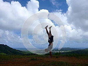 Man does a Handstand at Pali Highway lookout point