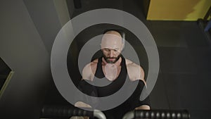 A man does a leg press on the exercise machine in the gym.