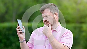 The man does not understand his new smartphone, does not know how to use
