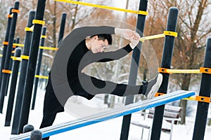 A man does push-ups in winter during morning sports.