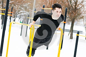 A man does push-ups in winter during morning sports.