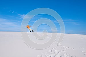 Man does a trick on the snowboard in the desert