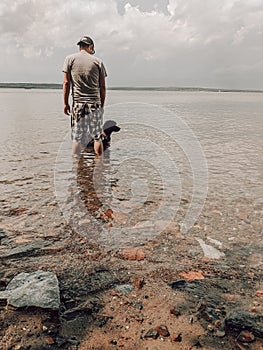 Man & Dog in Clear Shallow Water at Chequamegon Bay in Wisconsin