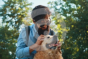 Man and dog having fun, playing, making funny faces while restin