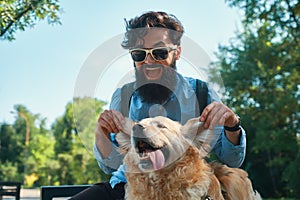 Man and dog having fun, playing, making funny faces while restin