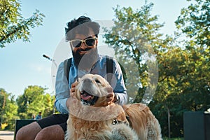 Man and dog having fun, playing, making funny faces while restin