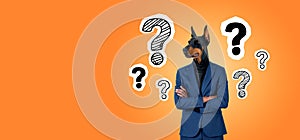 Man with dog head and arms crossed, question marks on copy space background