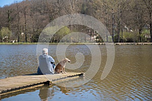 Man with dog on landing stage