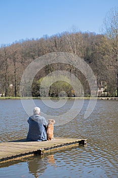 Man with dog on landing stage