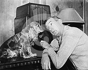 Man and dog listening to the radio