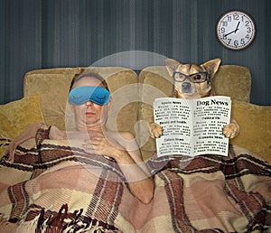 Man and dog with newspaper in bed