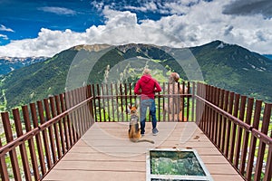 Man and dog overlooking at Andorra from observation deck.