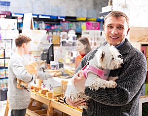 Man with dog in petshop