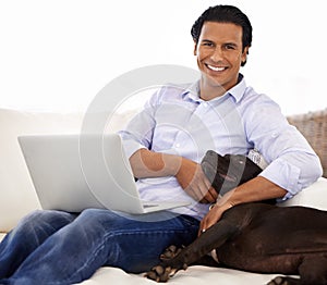Man, dog and portrait with laptop on sofa for bonding, playing or happiness with remote work in home. Animal, person and