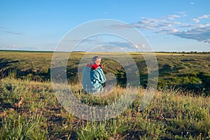 Man with a dog sitting in prairie