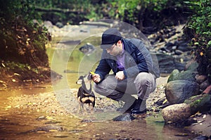 Man with dog at stream