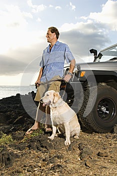 Man and Dog by SUV at the Beach