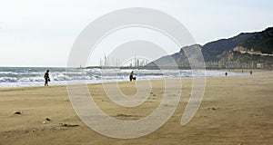 Man with dog on a windy day on the beach of Castelldefels