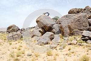 Man doing acrobatic movements on a rock