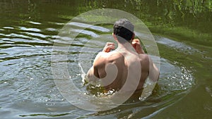 Man doing aqua aerobics, boxing in water